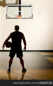 Basketball player alone in basketball court