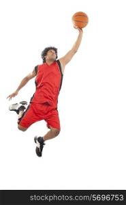 Basketball player in air preparing to dunk ball