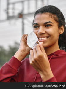 basketball player putting medical mask