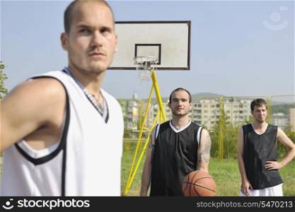 basketball player team group posing on streetbal court at the city on early morning