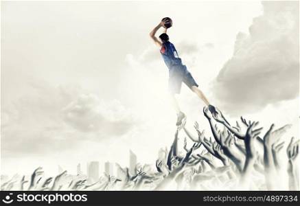 Basketball player. Young man basketball player with ball in hads jumping high