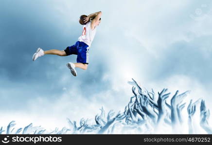 Basketball player. Young man basketball player with ball in hands jumping high