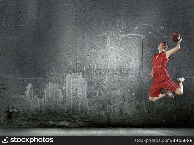 Basketball player. Young man basketball player with ball in hands jumping high