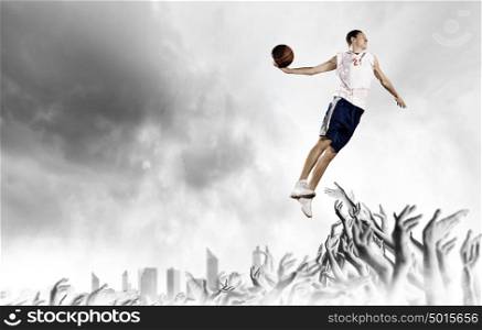 Basketball player. Young man basketball player with ball in hands jumping high