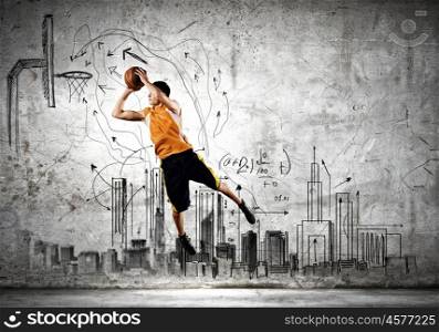 Basketball player. Young man throwing ball into basket in jump