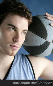 basketball young man basket player portrait over blue studio background