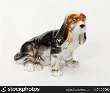 Basset Hound. Ceramic figurine, dog breed isolated on white