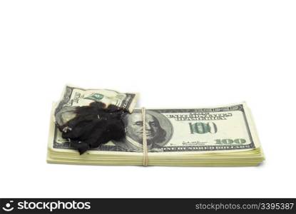 batch of 100 dollar bills tied with rubber band and half burnt 100 dollar bill lying on it, against white background