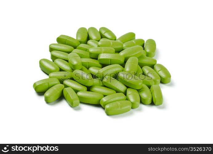 batch of green pills isolated on white