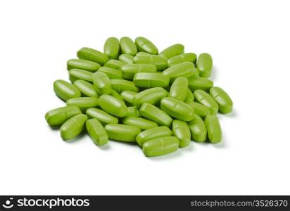 batch of green pills isolated on white