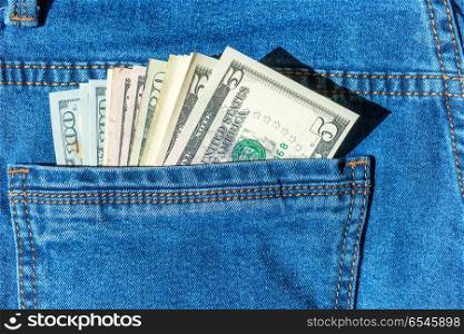 Batch of money in blue jeans pocket- dollar cash concept. Batch of money in blue jeans pocket