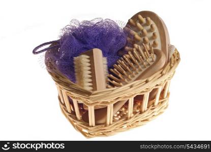 Bath anti-cellulitis spa massage kit with comb, brush, sponge and hairbrush in basket isolated on white background
