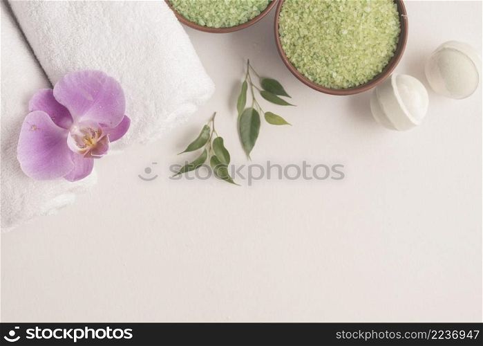 bath bombs herbal sea salt rolled up towels with orchid white backdrop