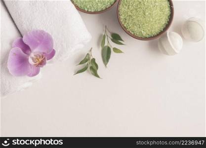 bath bombs herbal sea salt rolled up towels with orchid white backdrop