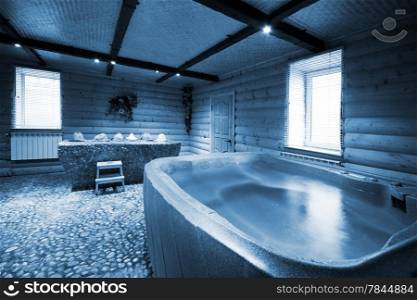 Bath with water in a beautiful wooden sauna