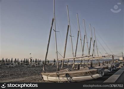 bathhouse and sailing boats on the seaside near the harbour channel of Cervia in Northern Italy on the Adriatic Sea