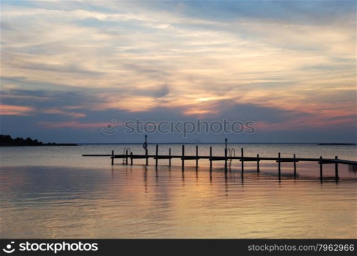 Bathing pier silhouette by a colorful cloude sunset