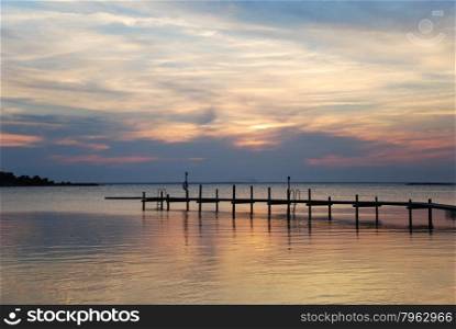 Bathing pier silhouette by a colorful cloude sunset