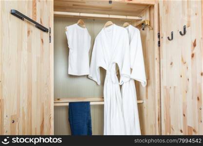 bathrobe and shirt, pants in wooden wardrobe