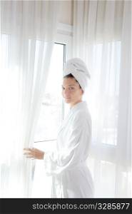 Bathrobe happy woman sunny hotel window white curtains
