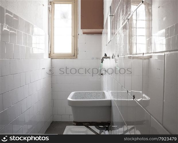 bathroom of a cell. &#xA;sink and toilet squat.