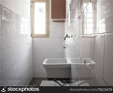 bathroom of a cell. &#xA;sink and toilet squat.