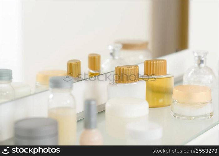 Bathroom shelf with beauty and hygiene products mirror reflection