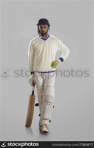 Batsman standing on grey background
