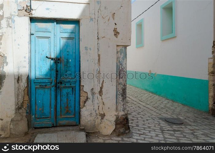 Battered Blue Front Door in Tunisian Street