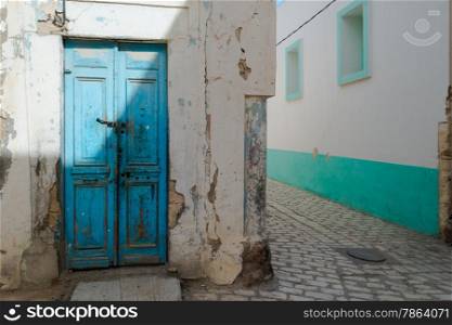 Battered Blue Front Door in Tunisian Street