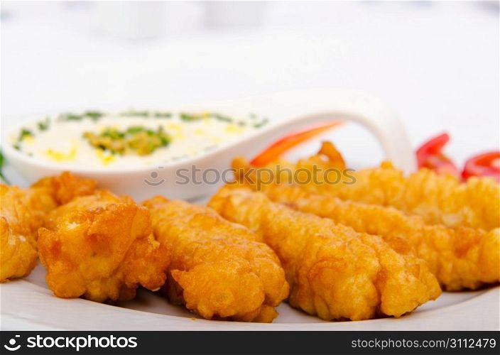 Battered chicken served with sauce