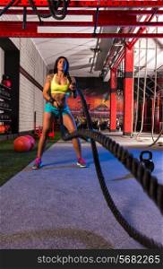 battling ropes girl at gym workout exercise fitted body