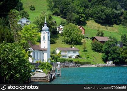BAUEN, SWITZERLAND - CIRCA AUGUST 2015 Church and houses near Lucerne lake