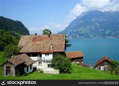 BAUEN, SWITZERLAND - CIRCA AUGUST 2015 Farm house and Lucerne lake