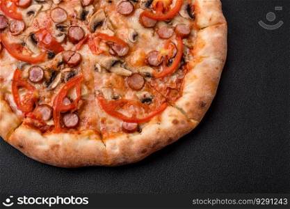 Bavarian pizza with smoked sausages, tomatoes, cheese, salt and spices on a dark concrete background