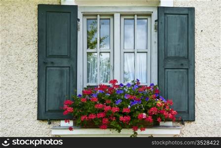 Bavarian Window With Open Wooden Shutters, Decorated With Fresh Flowers