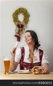 bavarian woman in a dirndl eating
