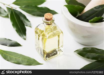 Bay laurel oil bottle with leaves and mortar