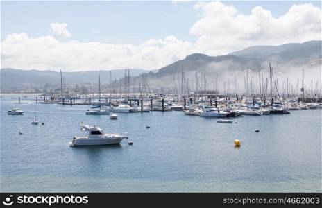 Bayona Sport port with fog covering sailboats