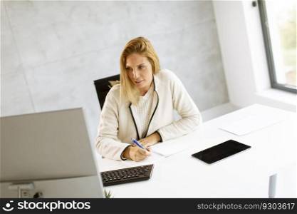 Bbeautiful businesswoman working on laptop in the bright modern office