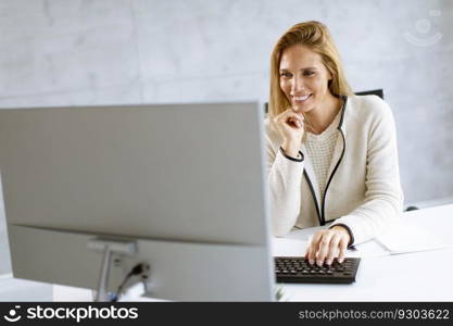 Bbeautiful businesswoman working on laptop in the bright modern office