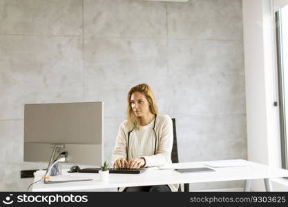 Bbeautiful businesswoman working on laptop in the bright modern office