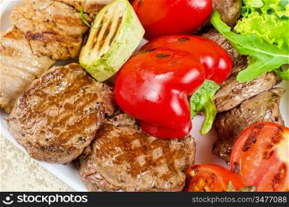 BBQ meat with vegetables and greens closeup