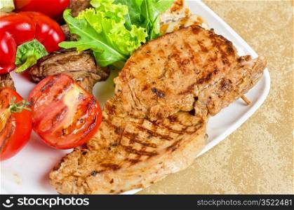 BBQ meat with vegetables and greens closeup