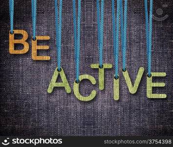 Be Active Letters hanging strings with blue sackcloth background.. Be Active