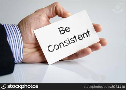 Be consistent note in business man hand