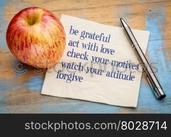 be grateful and other inspirational phrases - handwriting on a napkin with a fresh apple