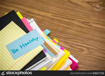 Be Healthy; The Pile of Business Documents on the Desk