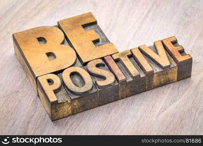 Be positive word abstract in vintage letterpress wood type