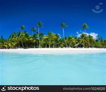 Beach and beautiful tropical sea. Caribbean summer sea with blue water. White clouds on a blue sky over summer sea. Tropical sea relax.